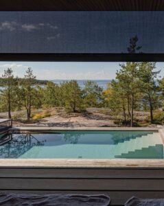 Half lowered roller shade with trees and a swimming pool in the background